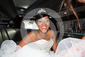 Pretty smiling african black american bride in marriage car