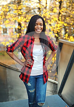 Pretty smiling african woman wearing a red checkered shirt