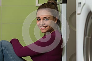 Pretty Smiling Girl In The Laundry Room