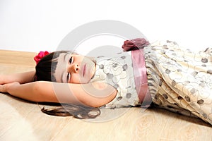 Pretty smiling girl lying on the floor at home.