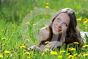 Pretty smiling girl relaxing outdoor in flowers