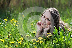 Pretty smiling girl relaxing outdoor in flowers