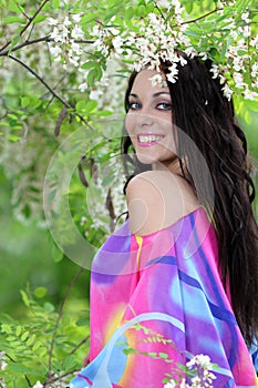 Pretty smiling girl relaxing outdoor in flowers