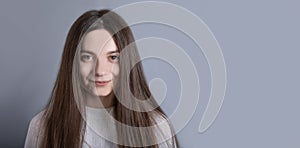 Pretty smiling joyfully female with dark hair, dressed casually, looking with satisfaction at camera, being happy. Studio shot of