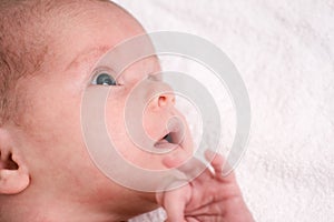 Pretty smiling newborn baby.