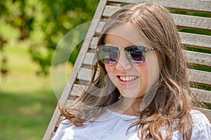 Pretty and smiling pre teen girl with sunglasses