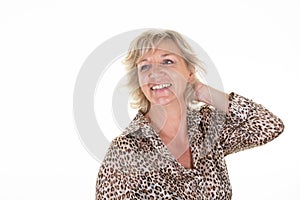 Pretty smiling senior sixties woman with blond hair elderly lady hand on head on white background