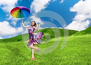 Pretty smiling woman with colorful umbrella