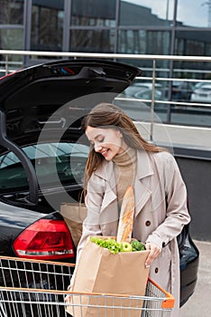 pretty, smiling woman holding shopping bag