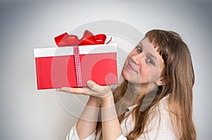 Pretty smiling woman with red gift box