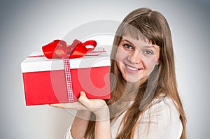 Pretty smiling woman with red gift box