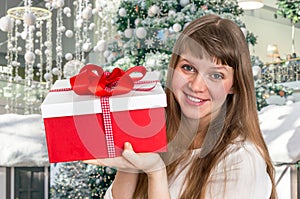 Pretty smiling woman with red gift box