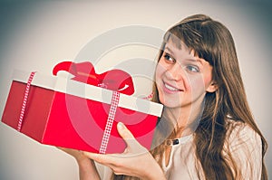 Pretty smiling woman with red gift box - retro style