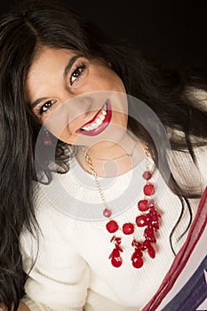 Pretty smiling woman with red lipstick and necklace
