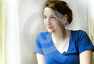 Pretty smiling young woman lost in thought