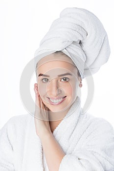 Pretty smiling young woman with white towel on her head