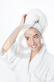 Pretty smiling young woman with white towel on her head