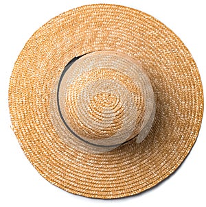 Pretty straw hat with ribbon and bow on white background beach hat top view