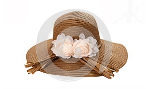 Pretty straw hat with ribbon and bow on white background. Beach hat top view isolated