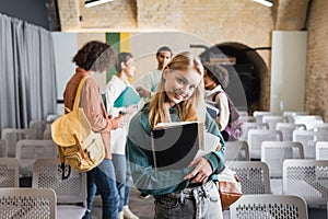 pretty student with copybooks smiling at