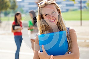 Pretty student girl with some friends at the campus