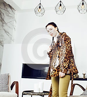 Pretty stylish woman in fashion dress with leopard print together in luxury rich room interior, lifestyle people concept