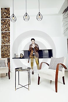 Pretty stylish woman in fashion dress with leopard print together in luxury rich room interior, lifestyle people concept