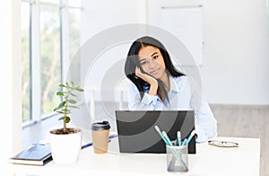 Pretty successful black businesswoman posing in modern office