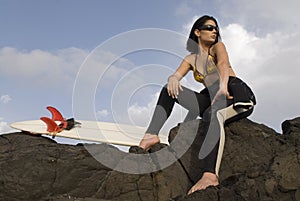 Pretty surfer girl waiting for waves