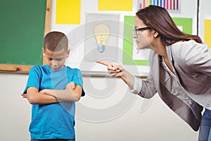 Pretty teacher reprimanding a pupil