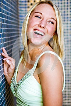 Pretty teen girl with blonde hair laughing