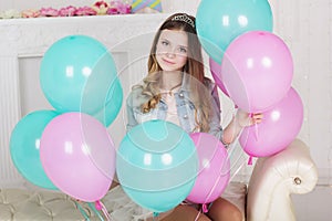 Pretty teen girl with many blue and pink balloons