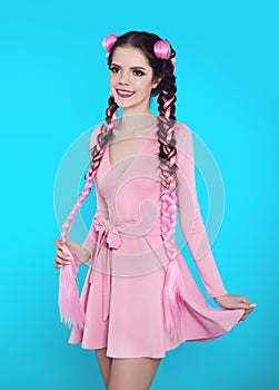 Pretty teen girl with two french braids from pink kanekalon, fashionable hairdo for youth, creative hairdresser beauty salon.