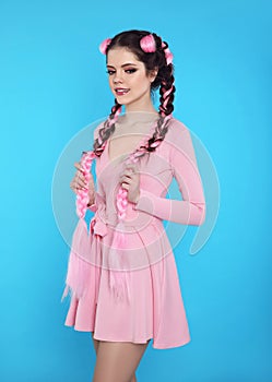 Pretty teen girl with two french braids from pink kanekalon, fashionable hairdo for youth, creative hairdresser beauty salon.