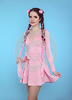 Pretty teen girl with two french braids from pink kanekalon, fashionable hairdo for youth, creative hairdresser beauty salon.