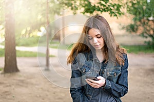 Pretty teen girl using phone in social media