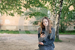 Pretty teen girl using phone in social media
