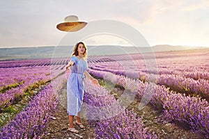 Pretty teen girl walking in lavender field