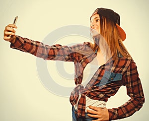 Pretty teen girl wearing hat, taking selfies