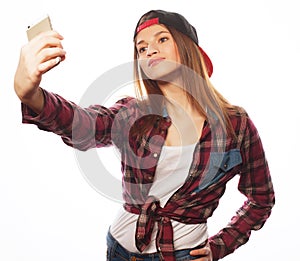 Pretty teen girl wearing hat, taking selfies