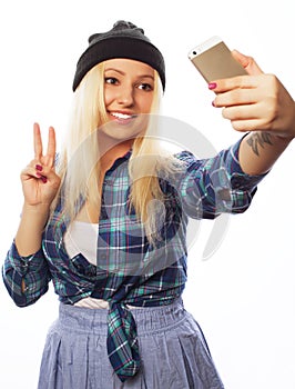 Pretty teen girl wearing hat, taking selfies