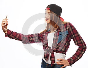 Pretty teen girl wearing hat, taking selfies