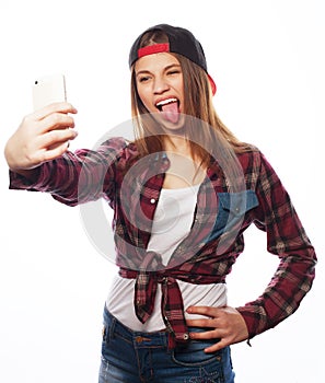 Pretty teen girl wearing hat, taking selfies