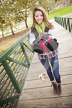 Pretty Teen Gives Wrapped Gift with Bow Outside