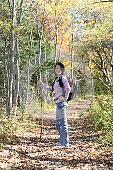 Pretty teen hiking outside in the fall