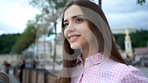 Pretty teen lady smiling in city center, sightseeing of attractions, tourism