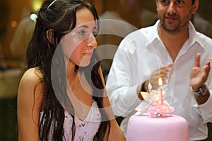 Pretty teen quinceanera birthday girl celebrating in princess dress pink party, special celebration of girl becoming woman.