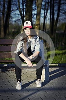 Pretty teenage girl on a bench