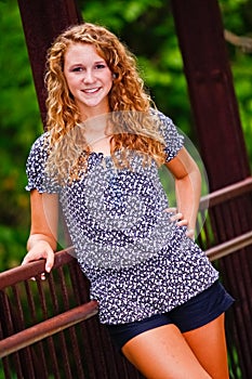 Pretty Teenage Girl on a Bridge in a Park