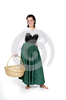 Pretty teenage girl in period dress holding basket